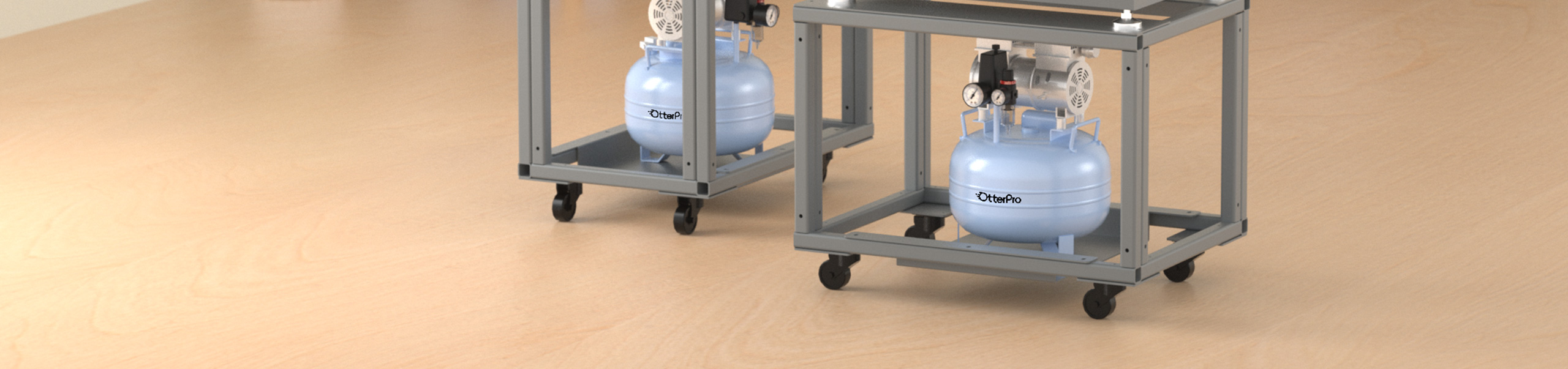 Two compact OtterPro air compressor tanks mounted under the mug press frames on a wooden table